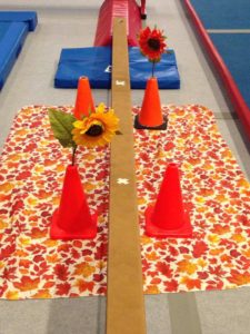 Fine motor skill development! When you get to the flower, squat to pick out of one pylon and replant it in the pylon on the other side. Harder than it looks for those little ones!